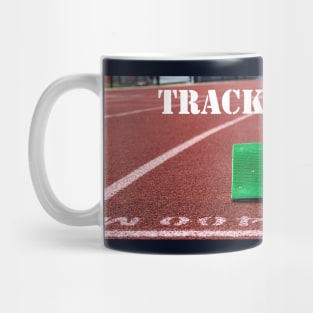 Track and field written above green starting blocks on a red track Mug